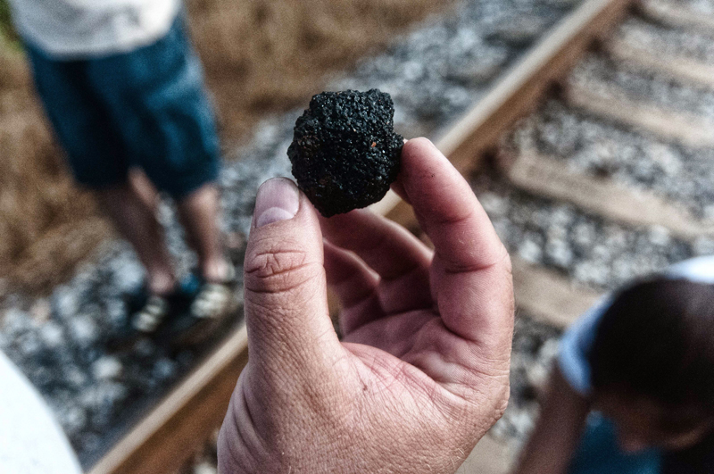 A Jaltipan neighbour shows a piece of solid pet coke in the perimeter of the storage facility. A Jaltipan neighbour shows a piece of solid pet coke in the perimeter of the storage facility.