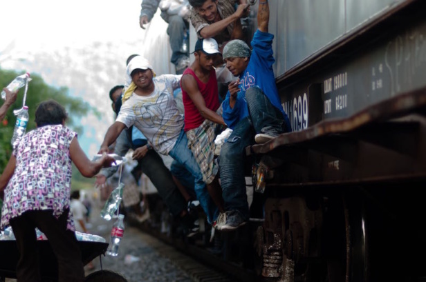 The Patronas handing the lunches to the migrants as the trains pass through La Patrona The Patronas handing the lunches to the migrants as the trains pass through La Patrona
