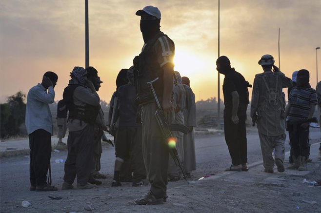 Fighters of the Islamic State of Iraq and the Levant (ISIL) stand guard at a checkpoint in the northern Iraq city of Mosul Fighters of the Islamic State of Iraq and the Levant (ISIL) stand guard at a checkpoint in the northern Iraq city of Mosul