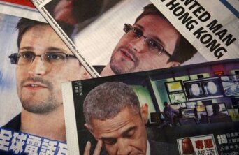 Photos of Snowden, a contractor at the NSA, and U.S. President Obama are printed on the front pages of local English and Chinese newspapers in Hong Kong in this illustration photo Photos of Snowden, a contractor at the NSA, and U.S. President Obama are printed on the front pages of local English and Chinese newspapers in Hong Kong in this illustration photo