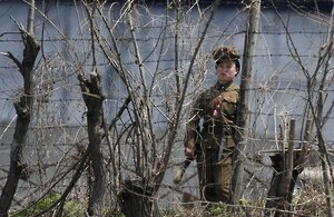 A North Korean prison policewoman stands guard behind fences at a jail on the banks of Yalu River near the Chongsong county of North Korea A North Korean prison policewoman stands guard behind fences at a jail on the banks of Yalu River near the Chongsong county of North Korea