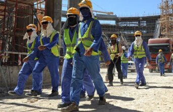 Foreign laborers work in Doha