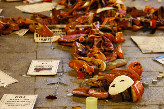 Red shoes representing blood and femicides in Sol, Madrid