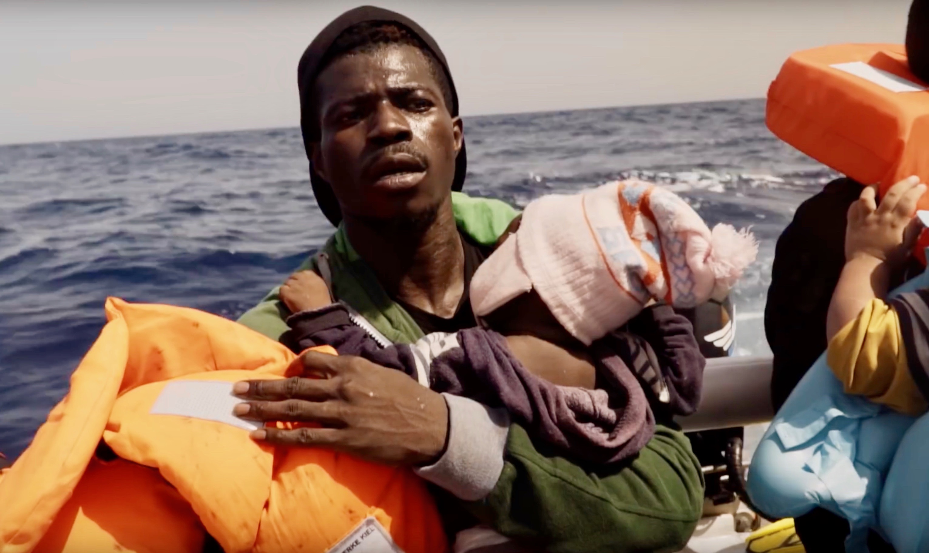 man with baby on rubber boat
