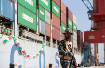 A soldier stands guard beside the Cosco Wellington, the first container ship to depart after the inauguration of the China Pakistan Economic Corridor port in Gwadar A soldier stands guard beside the Cosco Wellington, the first container ship to depart after the inauguration of the China Pakistan Economic Corridor port in Gwadar