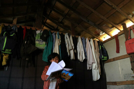 A Rohingya girl studying in her makeshift home in Jammu, Photo, Aakash Hassanhp
