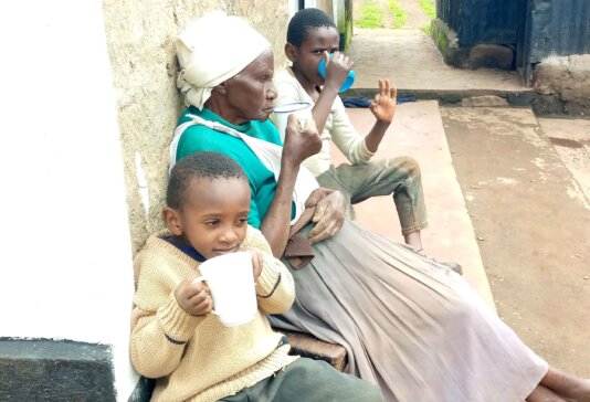 Sarah-Wanjiku2-Gichuhi-having-fortified-porridge-with-her-grandsons-Alex-and-Felix-at-home-in-Nakuru-County,-Kenya---photo-by-Joseph-Maina
