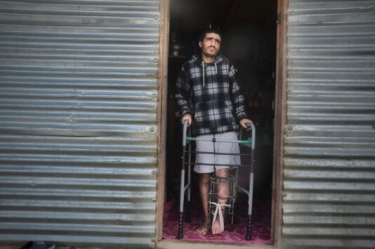 Bilal outside his tin shed home