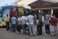 Returned migrants board a bus to Tegucigalpa in front the Center for Returned Migrants, San Pedro Sula airport, Honduras, September 2014. © 2014 Stephen Ferry for Human Rights Watch Returned migrants board a bus to Tegucigalpa in front the Center for Returned Migrants, San Pedro Sula airport, Honduras, September 2014. © 2014 Stephen Ferry for Human Rights Watch