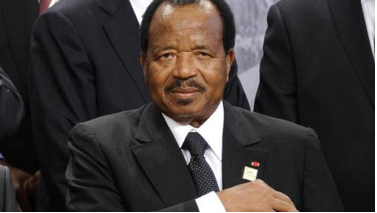 Photo of President Paul Biya getting ready to sign the bill against terrorism.