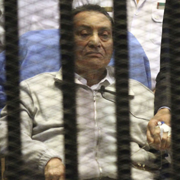 Egypt's ousted President Mubarak sits inside a dock at the police academy on the outskirts of Cairo