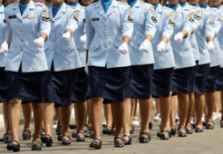 Women in uniform march during a ceremony