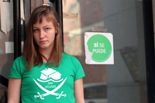 Lotta in front of the building of her “recuperated” apartment. The signboard of the PAH has the slogan “Yes, we can”.