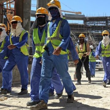 Foreign laborers work in Doha