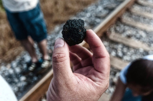 A Jaltipan neighbour shows a piece of solid pet coke in the perimeter of the storage facility. A Jaltipan neighbour shows a piece of solid pet coke in the perimeter of the storage facility.