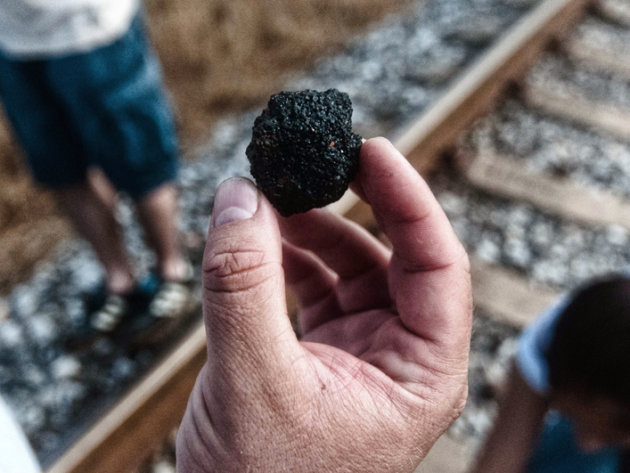 A Jaltipan neighbour shows a piece of solid pet coke in the perimeter of the storage facility. A Jaltipan neighbour shows a piece of solid pet coke in the perimeter of the storage facility.
