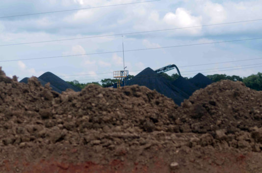 The hills of pet coke in the storage facility in Jaltipan