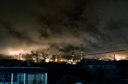 The glare produced by the burners of the plant chimneys is seen from several kilometers away at night. The glare produced by the burners of the plant chimneys is seen from several kilometers away at night.