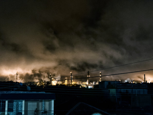 The glare produced by the burners of the plant chimneys is seen from several kilometers away at night. The glare produced by the burners of the plant chimneys is seen from several kilometers away at night.