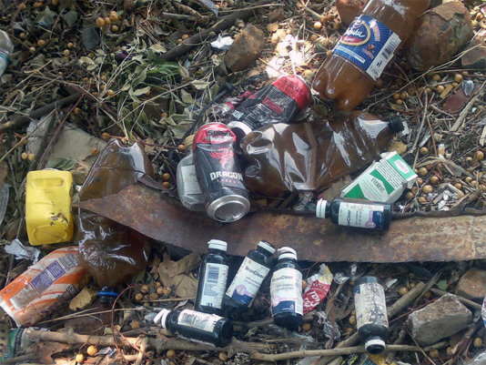 Discarded containers of Broncleer, Dragon energy drink , Chibuku Sorghum beer and Cigarettes in a backyard in Bulawayo