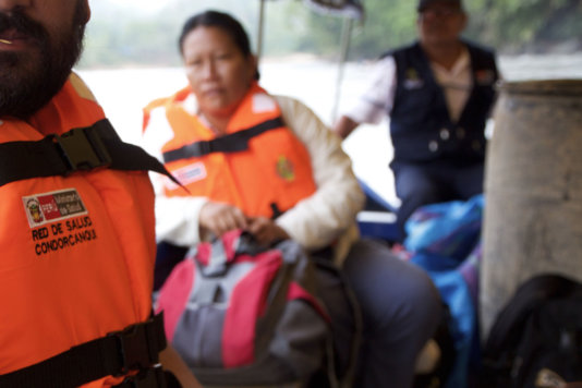 Peruvian medical staff travelling by boat on the Amazonas Peruvian medical staff travelling by boat on the Amazonas