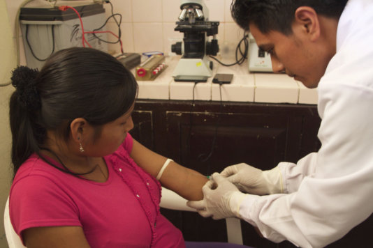 A doctor taking a blood sample from an Awajun A doctor taking a blood sample from an Awajun