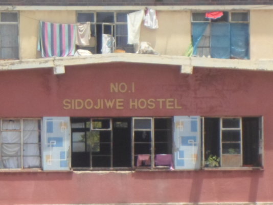 “In our room we are two families, and we have divided our sides using some old boards and curtains. I live with my two daughters and their children and we have come to accept what we have because we cannot afford the rentals in other places.”