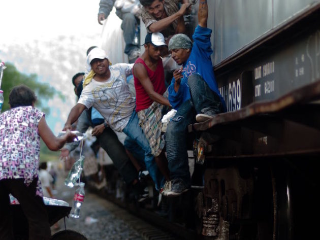 The Patronas handing the lunches to the migrants as the trains pass through La Patrona The Patronas handing the lunches to the migrants as the trains pass through La Patrona