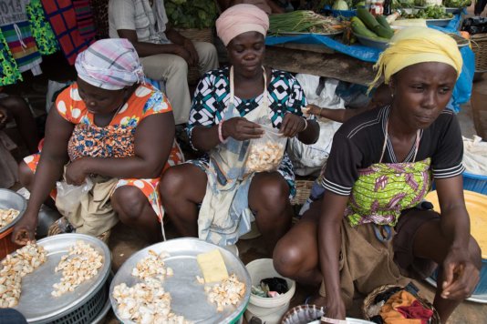Fishmongers selling clams in a<br /> market near Ada, Greater Accra<br /> Region Fishmongers selling clams in a<br /> market near Ada, Greater Accra<br /> Region