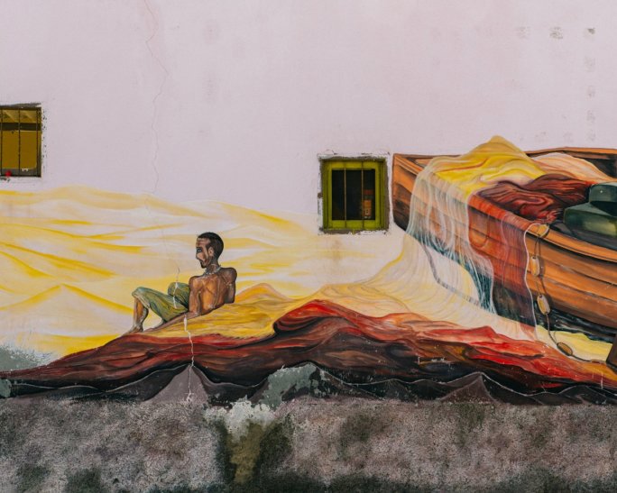 Mural of a man arriving by boat in Cape Verde.