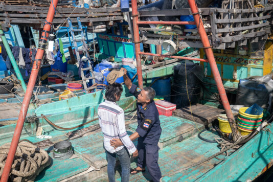 “I have been working on the boat for three or four years”. EJF communicates with a trafficked worker aboard a Thai fishing trawler during a trans-shipment at sea. The worker provided coordinates for the remote site where the fortnightly trans-shipment took place, allowing the team to document the transfer and alert authorities. A 2009 United Nations Inter-Agency Project on Human Trafficking (UNIAP) study found that 59% of trafficked migrants interviewed aboard Thai fishing vessels reported witnessing the murder of a fellow worker. RS27242_IMGL7378