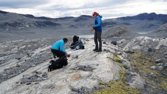 Co-authors Jessica Badgeley from the University of Washington (standing) and Alia Lesnek from the University at Buffalo collect rock samples in Greenland in August 2017. 1601502881186.png