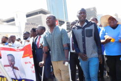 Tatenda Mombeyarara (with clutches) join a protest march against the abduction of Dr Peter Magombeyi in Harare