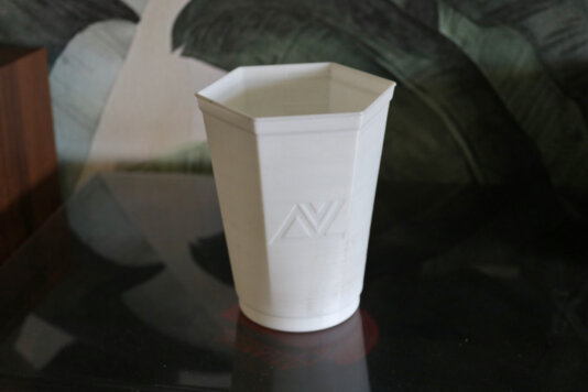 A biodegradable drinking cup made from recycled plastic created by Red Cup Village.