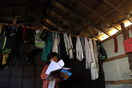 A Rohingya girl studying in her makeshift home in Jammu, Indian-administered Kashmir.