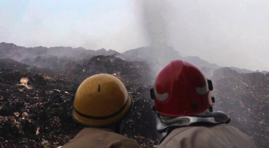 Firefighters trying to douse the flames at New Delhi\'s Bhalswa landfill.