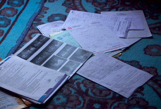 Rashid\'s medical reports scattered on the floor.