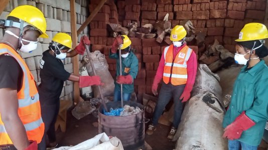 Pierre Sunday supervises the his collaborators as they melt plastic waste for blocks. Pierre Sunday supervises the his collaborators as they melt plastic waste for blocks.