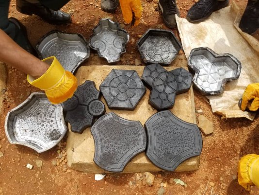 Samples of pavement tiles made by crushed and molten plastics.