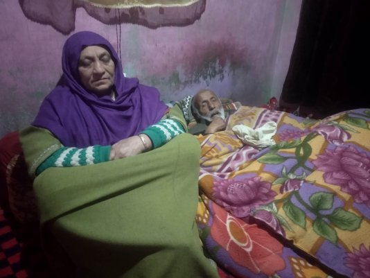 Abdul Rashid Dar\'s parents in the room where they last saw him.
