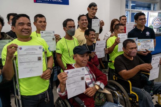 PWD participants receive driving license certificates in Manila, Philippines.