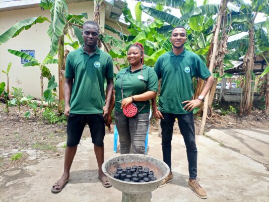 Mboza Clinton (right) and Tabe Brandon Njume (left) pose with a trainee.