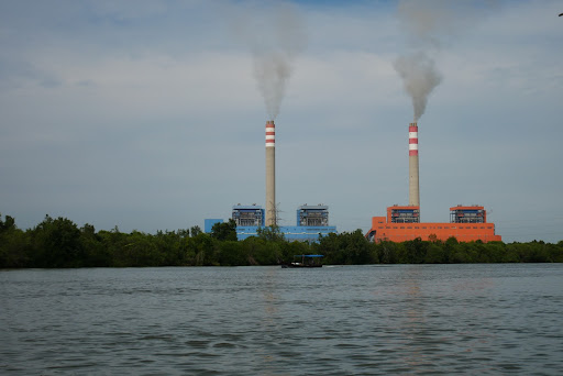 A Traditional fishing boat sails on the Siur River in Langkat Regency, North Sumatra, where a coal-fired power plant is being built.