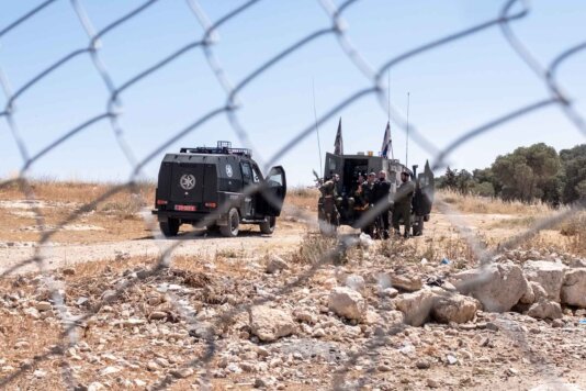 Israeli police and military outside of Musahbs’ home on a track leading from At-Tuwani to the Havat Ma’on settlement. Israeli police and military outside of Musahbs’ home on a track leading from At-Tuwani to the Havat Ma’on settlement.
