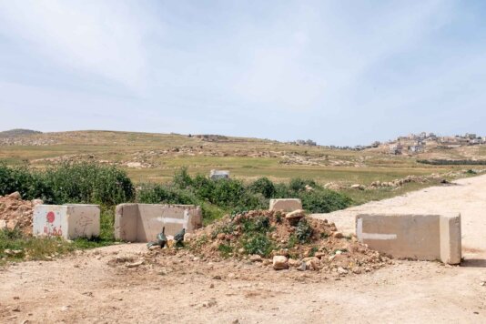 The main road leading from At-Tuwani to the city of Yatta, blocked by Israeli forces. The main road leading from At-Tuwani to the city of Yatta, blocked by Israeli forces.