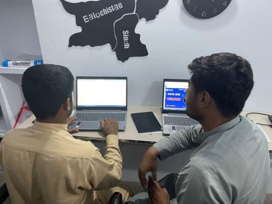 Volunteers operating laptops at Digital Dera Centre\'s community hall. Volunteers operating laptops at Digital Dera Centre\'s community hall.